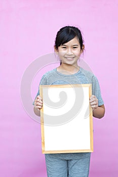 Little asian girl holding whiteboard