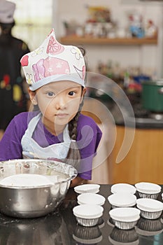 Little asian girl making cotton wool cake