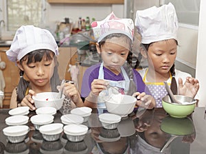 Little asian girl making cotton wool cake