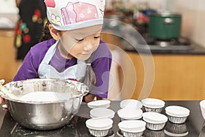 Little asian girl making cotton wool cake