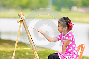 Little asian girl painitng