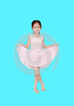 Little asian girl in pink leotard practise her ballet dance isolated on cyan background. Children is studying ballet
