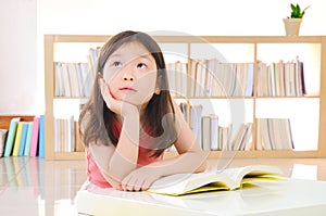 Little asian girl reading