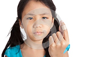 Little asian girl show finger with bandage focus at bandage