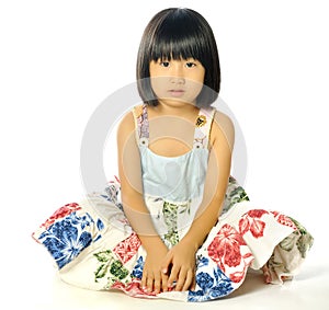 Little asian girl sitting on the floor