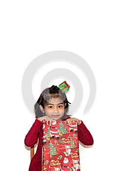 Little asian girl smile and excited and holding red gift box on white background.child holding gift box in Christmas and New year.