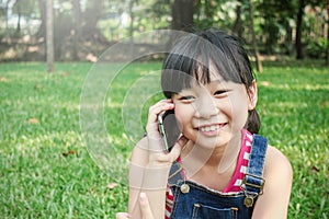 Little asian girl talking on cell phone