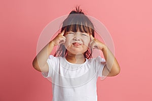 Little Asian girl of three years squinting is struggling to concentrate or remember important information, had a bad