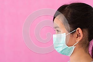 Little asian girl wearing sterile medical mask