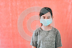 Little asian girl wearing sterile medical mask