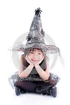 Little asian girl wearing witch costume for Halloween