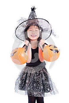 Little asian girl wearing witch costume for Halloween holding pu