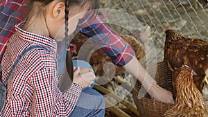 Little asian girl working at a hen farm.