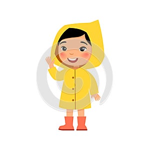 Little asian girl in a yellow raincoat smiles and waves a hand. Female child standing cartoon character.