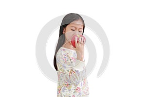 Little asian kid girl bite red apple isolated over white background