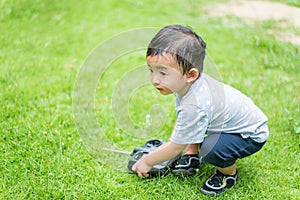 Little Asian kid holding a radio remote control controlling han