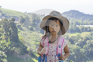 Little asian kids hiking mountain. Child mountaineer having fun while climbing a mountain with a backpack