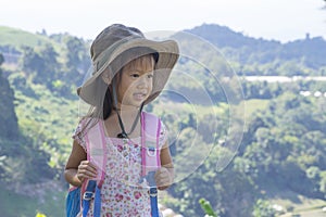 Little asian kids hiking mountain. Child mountaineer having fun while climbing a mountain with a backpack