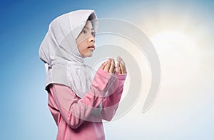 Little asian muslim girl praying to god