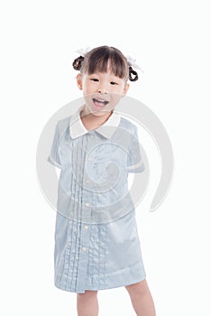 Little girl standing and smiling over white