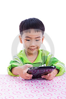 Little asian (thai) boy using digital tablet at desk