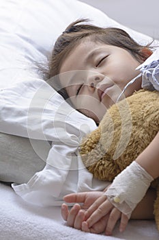 Little Asian Thai Girl, Recovering Sleep on white patient Bed