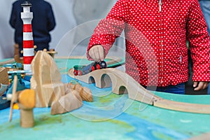 Little autistic boy playing with toy outdoor