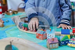 Little autistic boy playing with toy outdoor