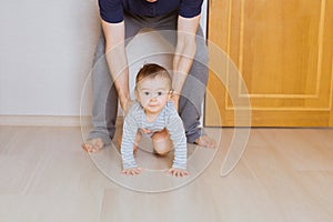 Little baby boy crawling on the floor at home