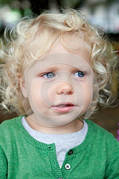 Little baby boy with curl hair and blue eyes