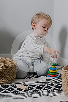 Little baby boy and developmental toys at home. Montessori for child development