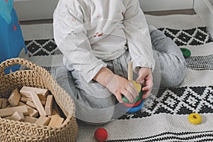 Little baby boy and developmental toys at home. Montessori for child development