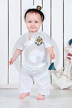 Little baby boy dressed as a sea captain.