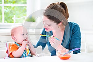 Little baby boy eating his first solid food