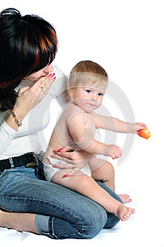 Little baby boy kissing mother