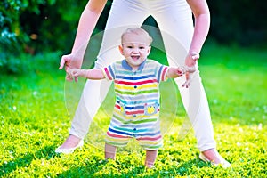 Little baby boy making first steps