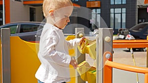 Little baby boy playing with colorful abacus and bricks on the playground. Children developments, kids education, baby learning