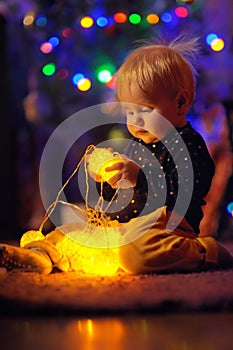 Little baby boy playing with illuminated toys