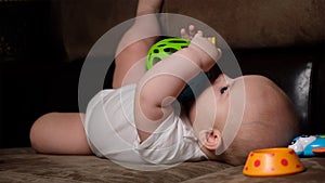 Little baby boy playing with plastic toys at home. Childhood, early development concept.