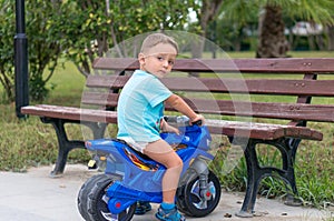 Little baby boy riding motobike