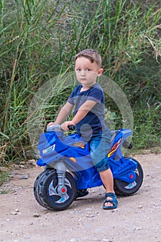 Little baby boy riding motobike photo