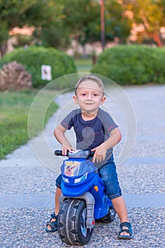 Little baby boy riding motobike photo