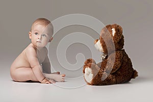 Little baby boy with teddy bear.