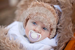 Little baby boy in warm winter clothes outdoor