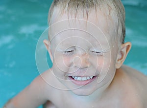 Little baby boy in the water pool