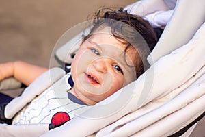 A little baby boy in a wheelchair