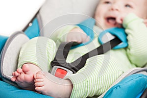 Little baby child in safety car seat