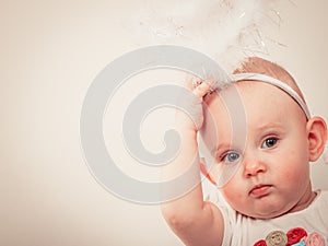 Little baby in christmas clothes and aureole photo