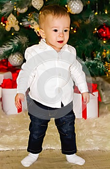 Little baby crawling near Christmas tree