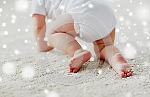 Little baby in diaper crawling on floor